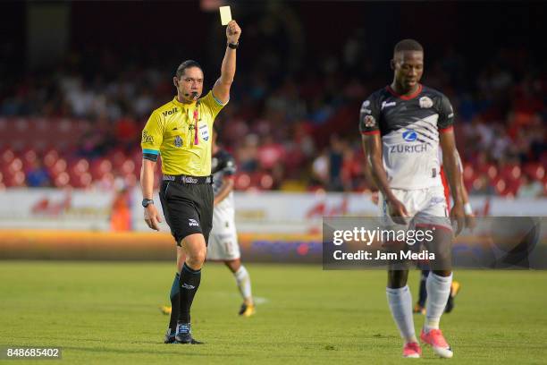 Referee Oscar Macias Romo shows a yellow card to Luis Advincula of Lobos Buap during the 9th round match between Veracruz and Lobos BUAP as part of...