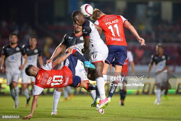 Luis Advincula of Lobos BUAP goes for a header with Cristian Menéndez of Veracruz during the 9th round match between Veracruz and Lobos BUAP as part...