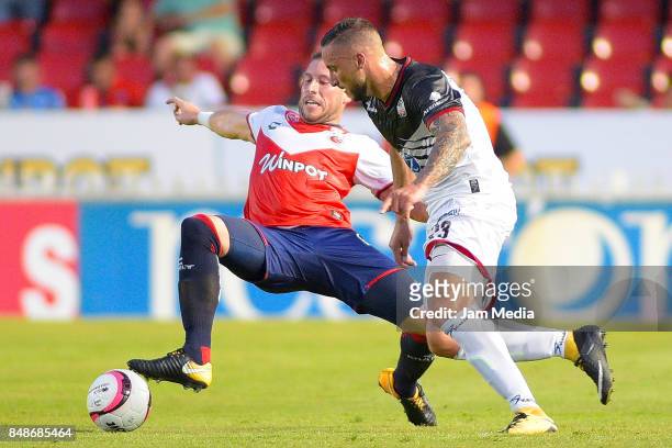 Jose Velazquez of Veracruz and Emmanuel Herrera of Lobos BUAP fight for the ball during the 9th round match between Veracruz and Lobos BUAP as part...
