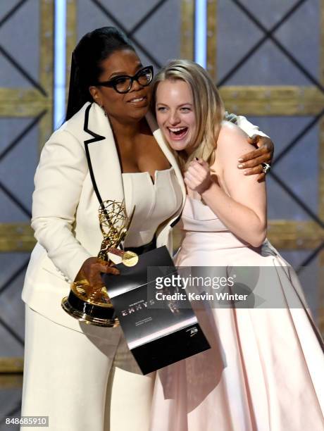 Actor Elisabeth Moss accepts Outstanding Drama Series for 'The Handmaid's Tale' from Oprah Winfrey onstage during the 69th Annual Primetime Emmy...