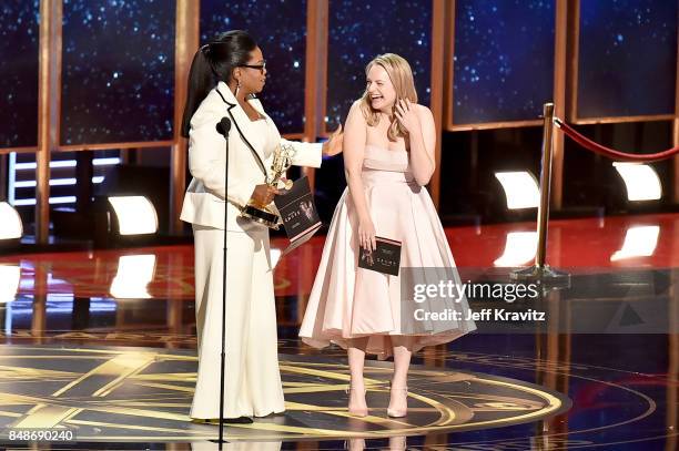 Oprah presents actor Elisabeth Moss with the Outstanding Lead Actress in a Drama Series award for 'The Handmaid's Tale' onstage during the 69th...
