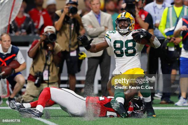 Keanu Neal of the Atlanta Falcons tackles Ty Montgomery of the Green Bay Packers during the first half at Mercedes-Benz Stadium on September 17, 2017...