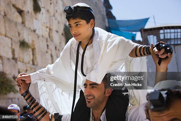 a father carries his son at the western wall - bar mitzvah stock pictures, royalty-free photos & images