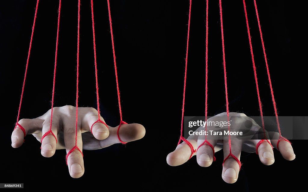 Hands being supported by string