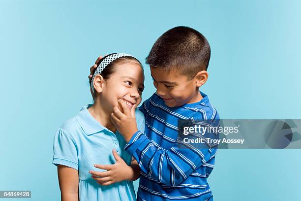 little brother making sister smile - troy bond stock pictures, royalty-free photos & images