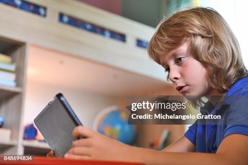 Kid Coding Tablet Kids Coding Young Boy Using Tablet At Home High-Res Stock Photo - Getty ...