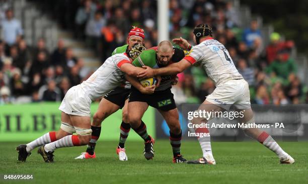 Saracens' Steve Borthwick and Kelly Brown tackle Harlequins' Joe Marler during the Aviva Premiership match at Twickenham Stoop, Middlesex.