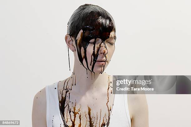 woman with chocolate running down face - chocolate face stock pictures, royalty-free photos & images