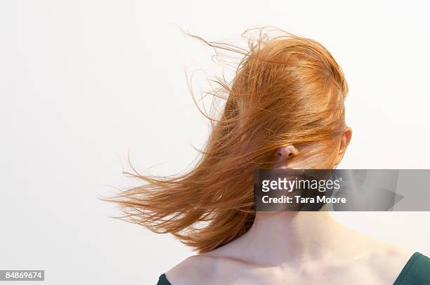 woman with hair blowing over face - haare stock-fotos und bilder