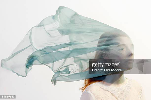 woman with veil blowing over face - veil stockfoto's en -beelden