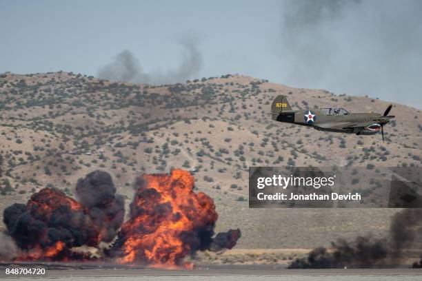 Airplane participates in a battle reenactment show at the Reno Championship Air Races on September 17, 2017 in Reno, Nevada.