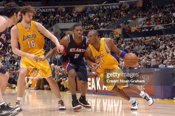 Kobe Bryant of the Los Angeles Lakers drives past Joe Johnson of the Atlanta Hawks at Staples Center on February 17, 2009 in Los Angeles, California....