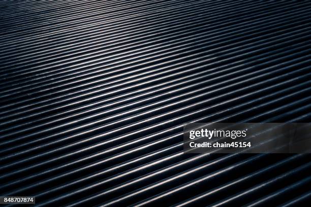 steel of pipe, cylindrical metal pipes while sun shining metal pipes. - steel tubing stock pictures, royalty-free photos & images