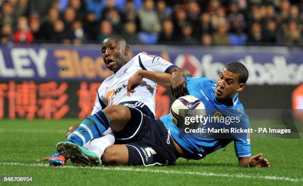 Bolton Wanderers Benik Afobe battles for the ball with Leeds United's Lee Peltier during the npower Championship match at the Reebok Stadium, Bolton.