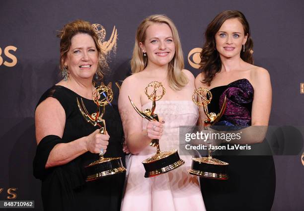 Actors Ann Dowd, Elisabeth Moss, and Alexis Bledel, winners of the award for Outstanding Drama Series for 'The Handmaid's Tale,' pose in the press...