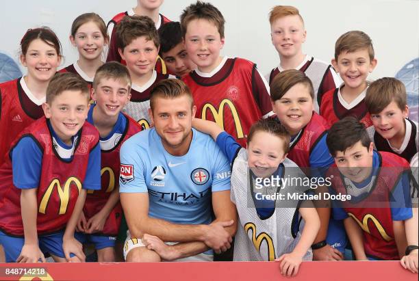 New marquet signing Marcin Budzinksi poses with McDonalds Junior program kids during a Melbourne City A-League press conference at the City Football...