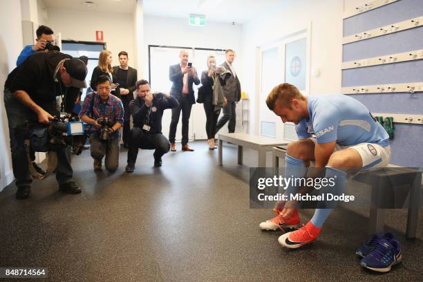New marquet signing Marcin Budzinksi laces up during a Melbourne City A-League press conference at the City Football Academy on September 18, 2017 in...