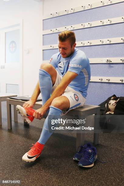 New marquet signing Marcin Budzinksi laces up during a Melbourne City A-League press conference at the City Football Academy on September 18, 2017 in...