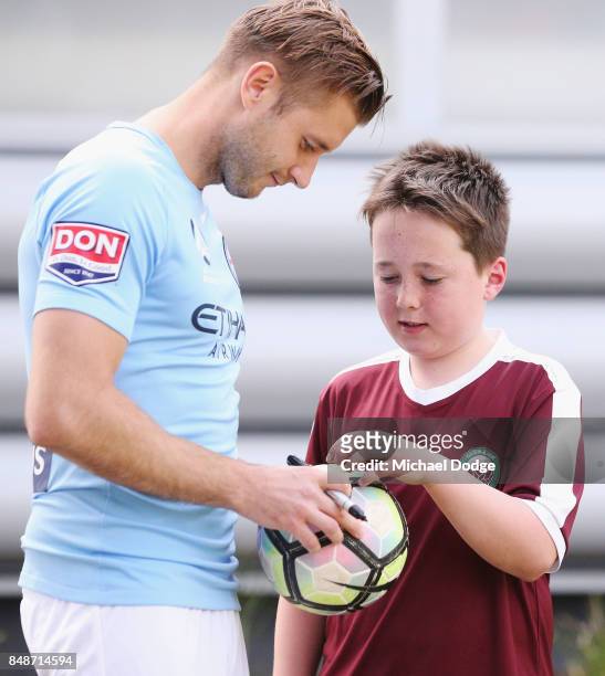 New marquet signing Marcin Budzinksi signs autographs for McDonalds Junior program kids during a Melbourne City A-League press conference at the City...