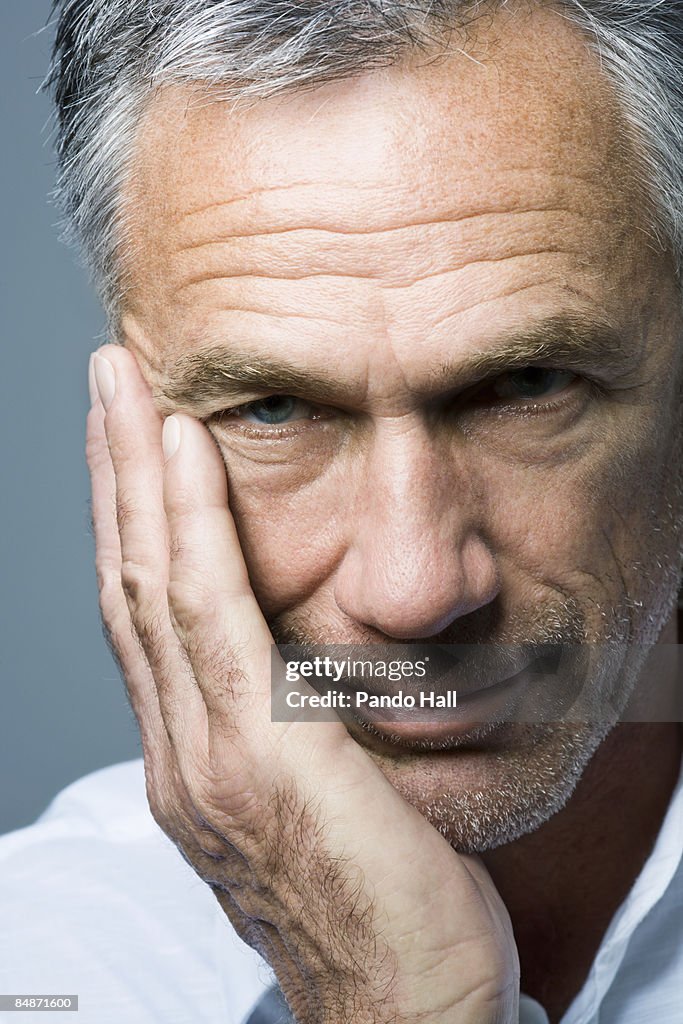 Portrait of a man with hand on cheek, close-up