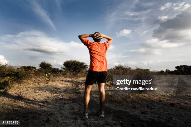 runner - hands behind head stock pictures, royalty-free photos & images