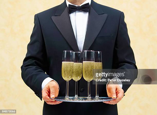 waiter, butler, with four glasses of champagne. - butler stock pictures, royalty-free photos & images