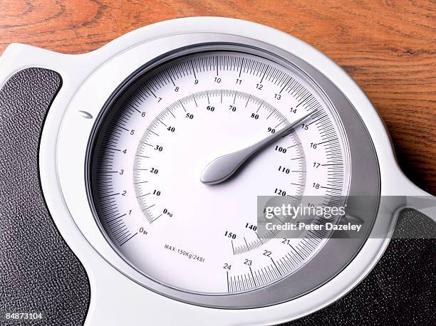 bathroom scales on wooden floor. - bathroom scales stock pictures, royalty-free photos & images