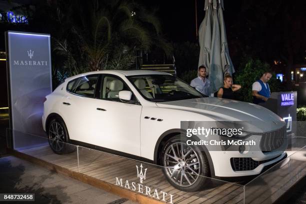 People walk past a Maserati display outside the Yacht Club on September 16, 2017 in Bodrum, Turkey. Bodrum and the Bodrum Peninsula famous for being...