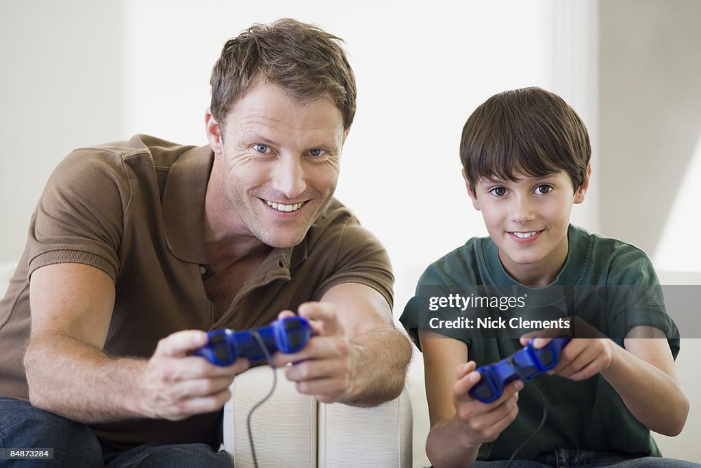 Father and son (10-11 years) playing video games