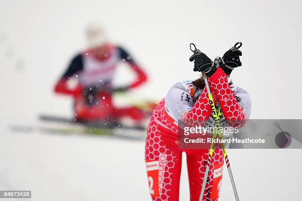 An exhausted Katja Visnar of Slovenia reacts after crossing the finish line during the Ladies 5KM Individual Classic Qualification Race at the FIS...
