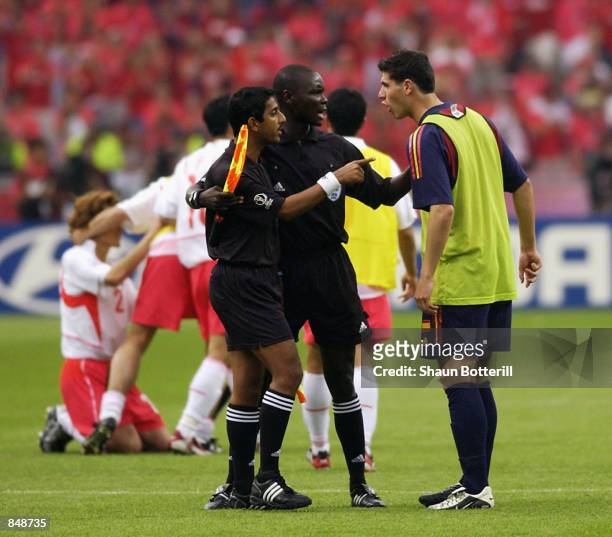 Albert Luque of Spain argues with Assistant Referees Ali Tomusange and Michael Ragoonath after the FIFA World Cup Finals 2002 Quarter Finals match...