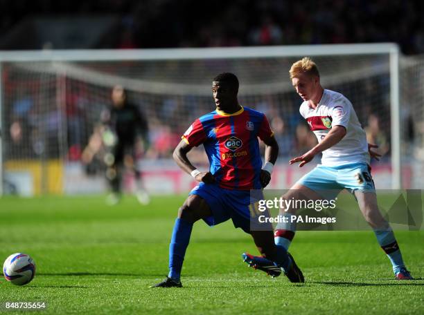 Crystal Palace's Wilfried Zaha and Burnley's Ben Mee battle for the ball during the npower Football League Championship match at Selhurst Park,...