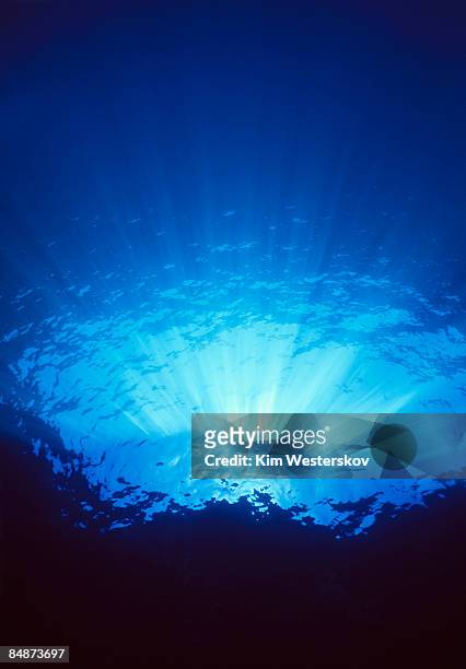 sunlight shining thru clear water over cliff edge - westerskov stock pictures, royalty-free photos & images