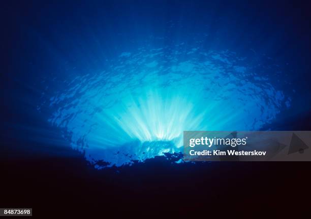 sunlight shining thru clear water over cliff edge - westerskov stock pictures, royalty-free photos & images