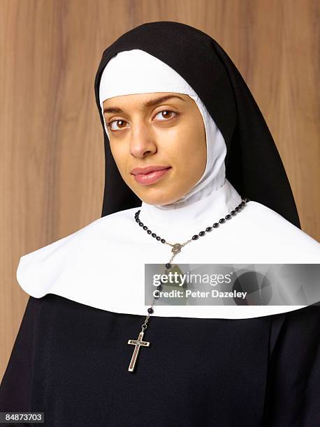 portrait of nun with crucifix. - nun habit stock pictures, royalty-free photos & images