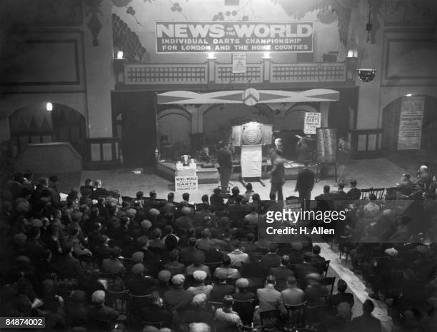 Crowd watches the semi-finals of the News Of The World Individual Darts Championship for the Ilford and Romford area, at the Palais De Danse, Ilford,...