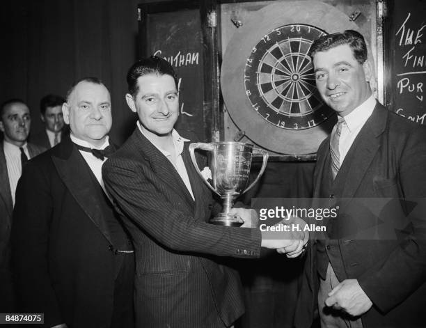 Southam is congratulated by runner-up J. Purl after he won the News Of The World Individual Darts Championship final for the Tunbridge Wells area at...