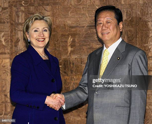 Visiting US Secretary of State Hillary Clinton shakes hands with Japan's main opposition Democratic Party of Japan leader, Ichiro Ozawa, prior to...