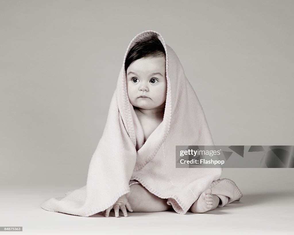Portrait of baby wrapped in blanket