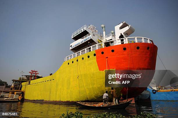 Bangladeshi labour paints a ship in a dockyard beside the Buriganga River in Dhaka on February 17, 2009. Twenty-eight dockyards occupying 30.96 acres...