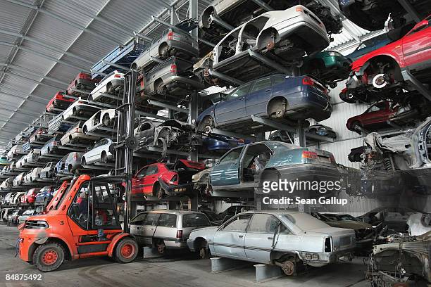 Forklift sets a car body in its place in a giant hangar at Berk car salvage on February 18, 2009 in Berlin, Germany. The German government has...