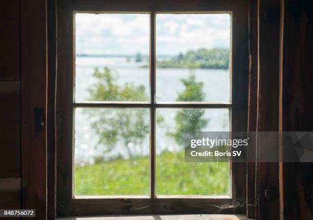 view of lake from cottage window - marco de ventana fotografías e imágenes de stock