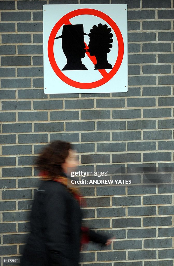 A sign depicting a no kissing zone is pi