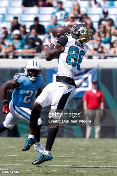 Wide Receiver Allen Hurns of the Jacksonville Jaguars makes a catch over Strong Safety Da'Norris Searcy of the Tennessee Titans at EverBank Field on...