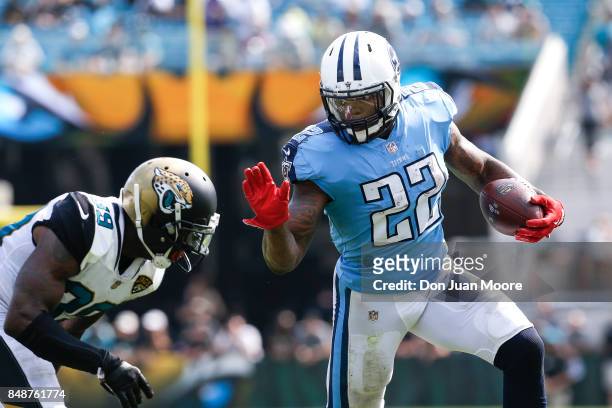 Runningback Derrick Henry of the Tennessee Titans avoids a tackle by Free Safety Tashaun Gipson of the Jacksonville Jaguars during the gameat...