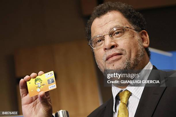 Danny Jordaan, Chief Executive officer of the 2010 lWorld Cup local organizing committee, holds a payment card that will be issued after an...