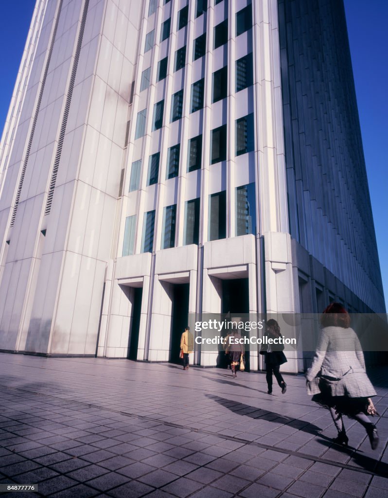 Commuters entering modern office building