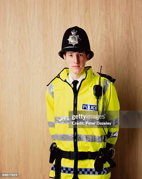 very young british police constable smiling. - police officer uk stock pictures, royalty-free photos & images