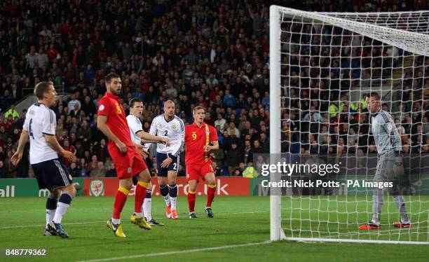 Wales's Steve Morison misses a chance on goal as the other players look on