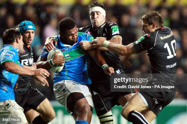 Benetton Treviso's Manoa Vosawai is tackled by Osprey's Ryan Jones and Dan Biggar during the Heineken Cup match at the Liberty Stadium, Swansea.